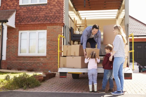 Removal team carrying items from a Chiswick flat with stairs